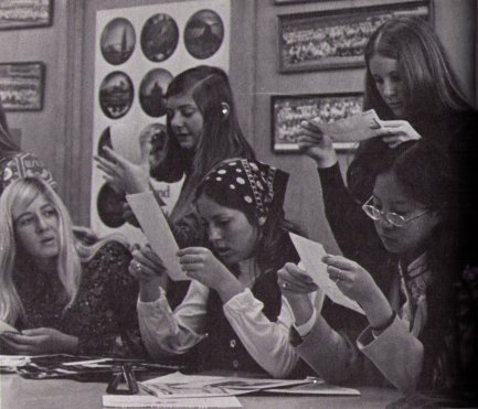 Student council looking at contact prints